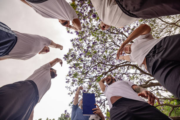 Young men come together in Sydney for a soccer training session, filled with enthusiasm and teamwork as they celebrate their progress and shared goals. Their camaraderie is evident.