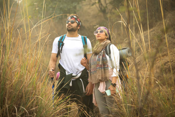 istock Young couple in sunglasses standing in forest 2196216586