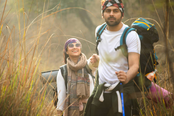 istock Young couple holding hands and hiking in forest 2196216649
