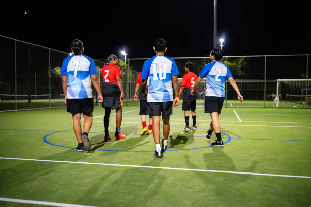 istock Mixed Gender Team Playing Football Match on Artificial Turf at Night 2196216687