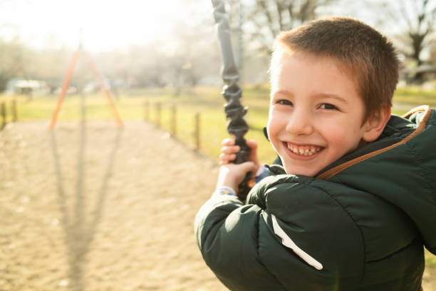 Cute 4 year old boy on a zip-line