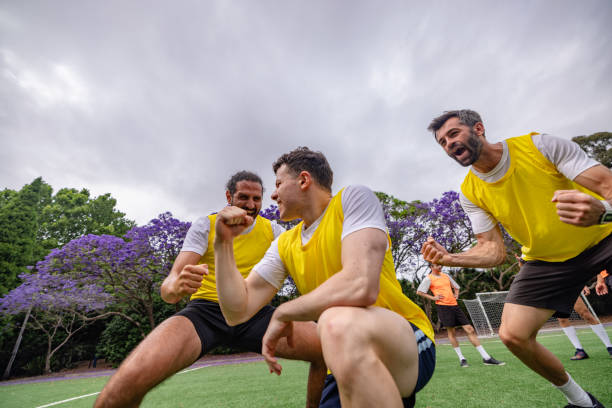 istock Men celebrate teamwork and success while playing soccer on a vibrant field in Sydney, Australia during a training session 2196220056