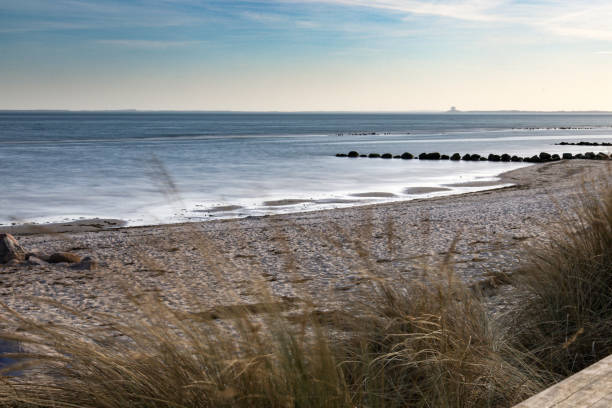 istock A beach with a calm ocean and a few rocks 2196222252