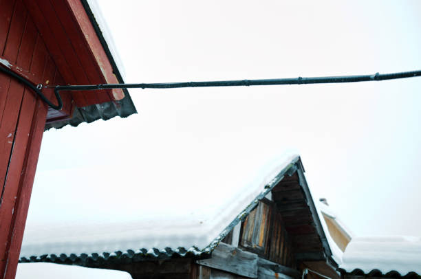 electric cable hanging between two houses, winter shot
