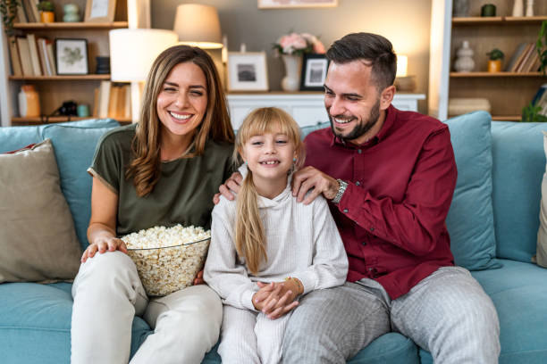 istock Young family watching a TV at home 2196224528