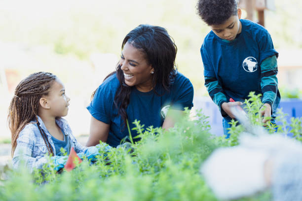 istock Happy Volunteers Working Together in Community Garden 2196224728