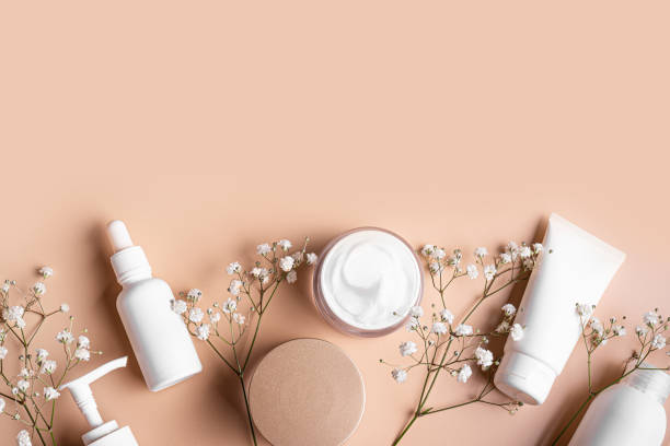 istock White cosmetic containers and gypsophila flowers 2196225067
