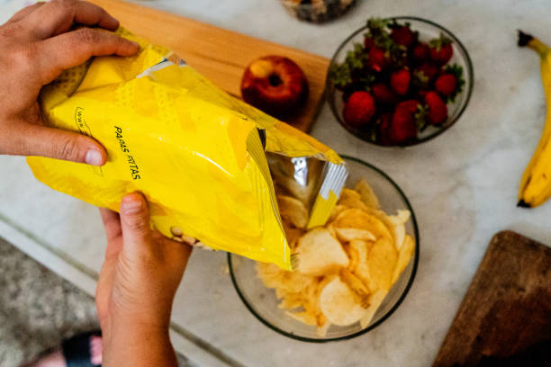 Potato chips in open bag, delicious BBQ seasoning spicy for crips, thin slice deep fried snack fast food.