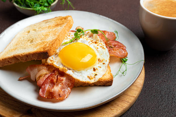 istock Healthy breakfast. Toast with fried egg, bacon and microgreens 2196226066