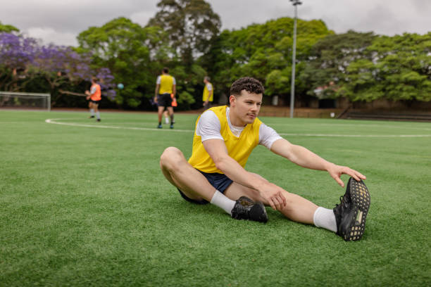 istock Men stretching on a soccer field in Sydney, embracing teamwork and athleticism 2196228002