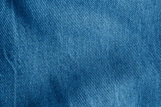 texture or background of blue jeans with shadows and abrasions