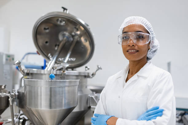 istock A latino female worker in pharmaceutical production poses at her workplace 2196233700