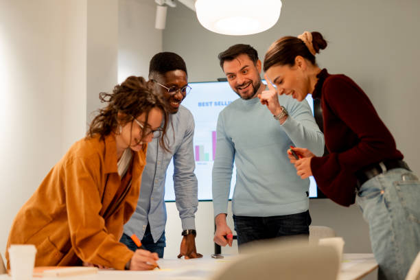 istock Marketing team working together on a project in the office 2196235571