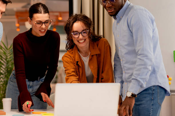 istock Young Professionals Collaborating on Laptop in Modern Office 2196235597