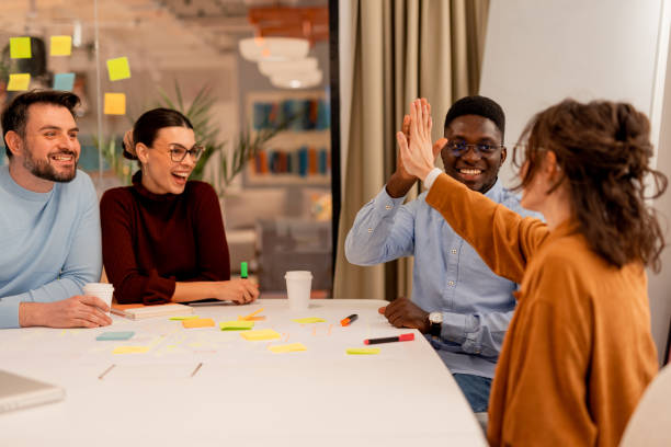 istock Marketing team giving high five after successful brainstorming session 2196235728