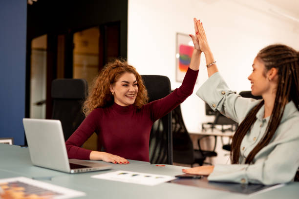 istock Two Colleagues Celebrating With a High Five in a Modern Office Setting 2196235745