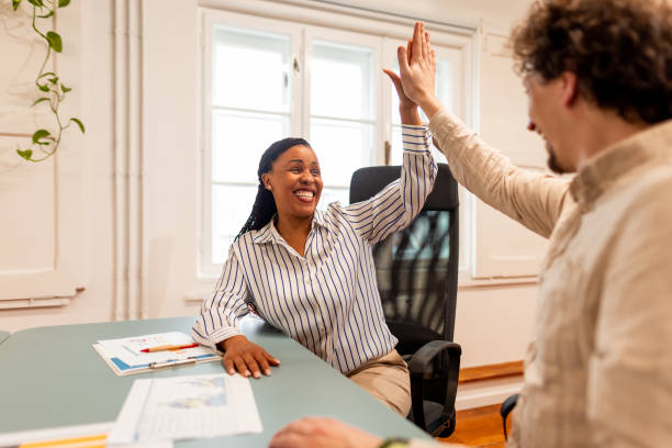 istock Coworkers Celebrating Success With a High-Five in Office Environment 2196235748