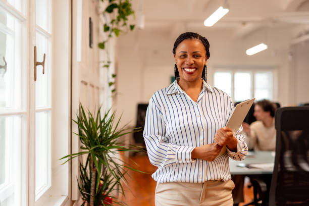 istock Confident Professional Businesswoman in Modern Office Environment Holding a Tablet 2196235840