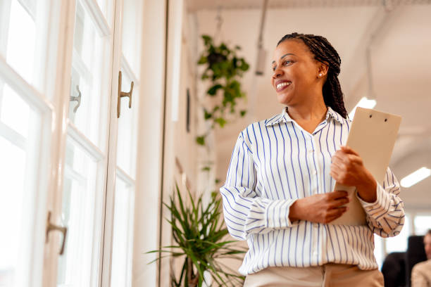 istock Professional Woman Smiling Confidently in a Modern Office Environment 2196235887