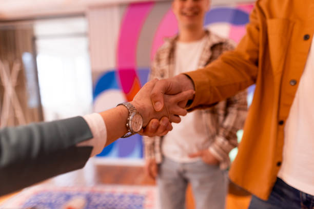 istock Real estate agent shaking hands with clients in new apartment 2196235930