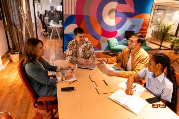 istock Marketing team analyzing graphs and discussing project strategy during a meeting in the office 2196235938