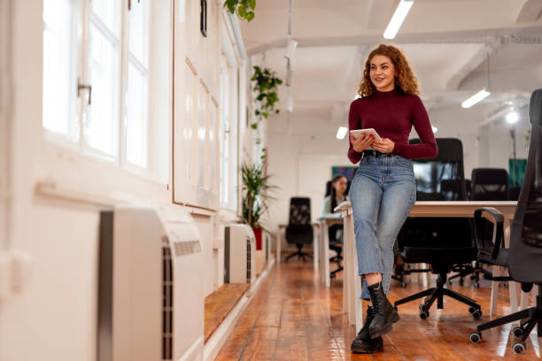 istock Young Woman Working on a Tablet in a Modern Office Environment 2196235946