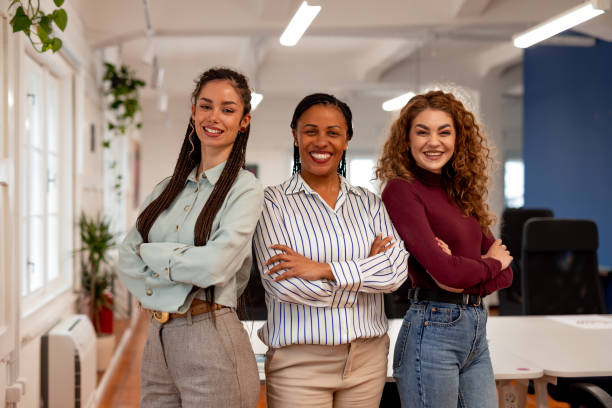 istock Confident Diverse Women Smiling in a Modern Workplace Environment 2196236141