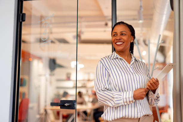 istock Confident Professional Woman Holding Documents in Modern Office Environment 2196236173