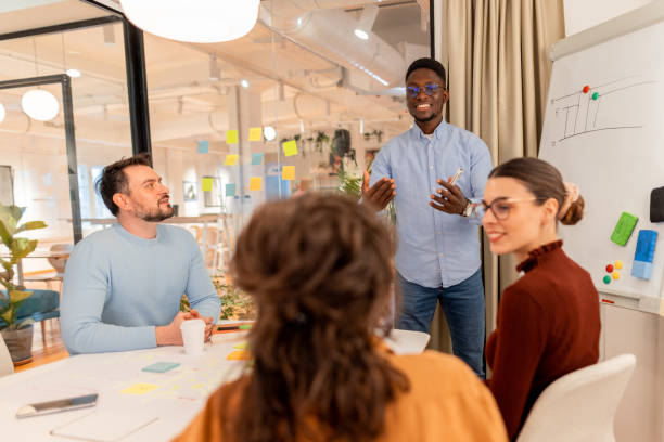 istock Young African American manager leading a brainstorming meeting with his team 2196236196