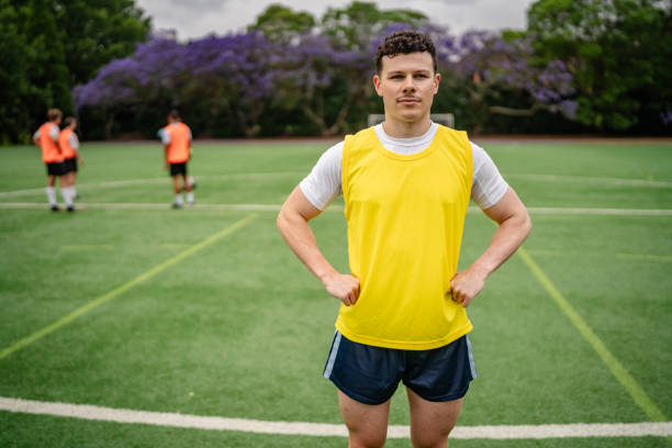istock Young men practicing teamwork and soccer skills on a green field in Sydney, Australia during a sports training session 2196236372