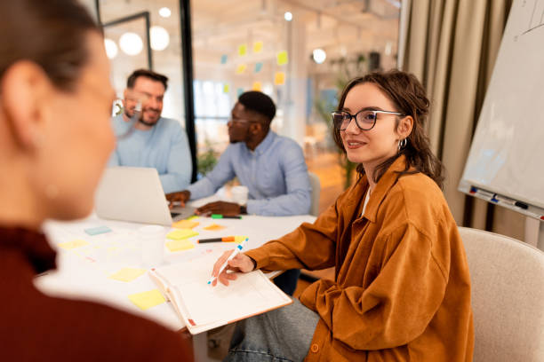 istock Young people working together at the office taking notes during a meeting 2196236532