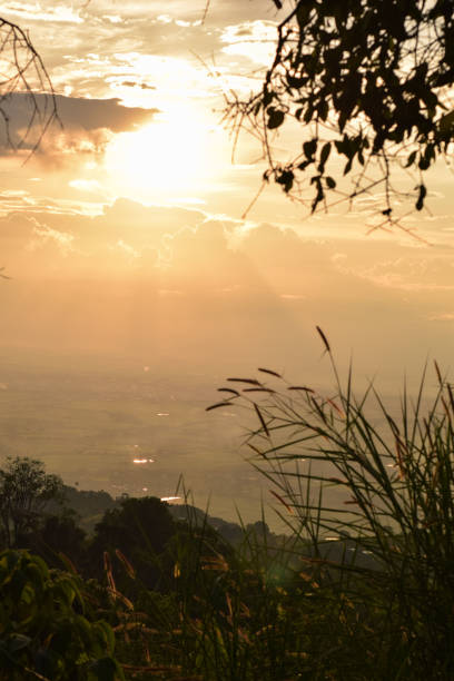 A breathtaking landscape capturing the view of a serene valley as seen from the heights of a mountain. The scene showcases lush greenery, and expansive skies, evoking a sense of tranquility and natural beauty.