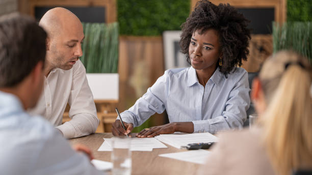 istock Woman leads dynamic meeting with colleagues, highlighting effective communication and teamwork. 2196237679