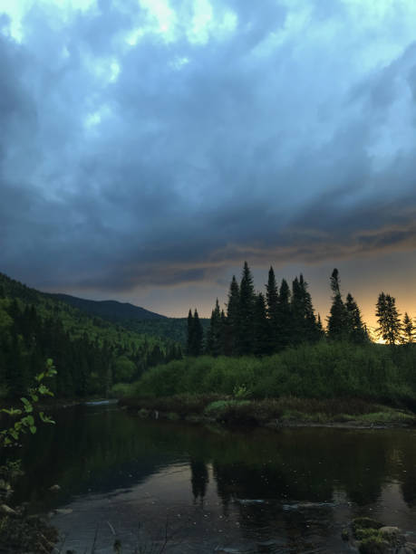 istock Beautiful View of Quebec Forest, Mountains, and River during Summer Sunset 2196237811