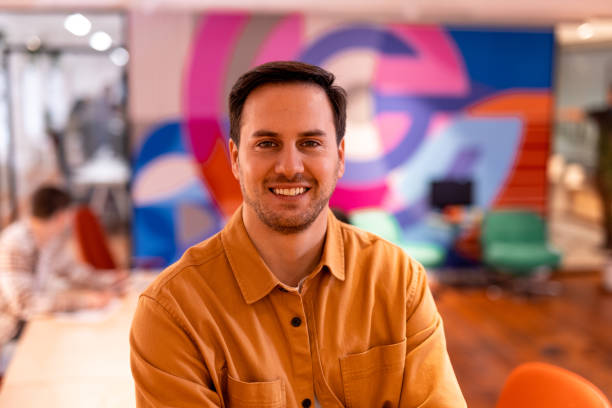 istock Young businessman smiling in modern office with colorful background 2196237914