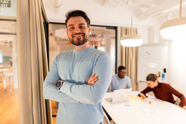 istock Confident young manager smiling with crossed arms in modern office 2196237951
