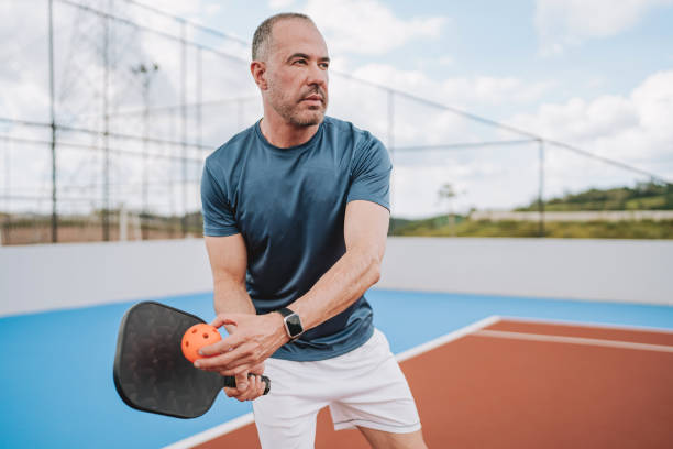 istock Portrait of man playing pickleball serve 2196237985