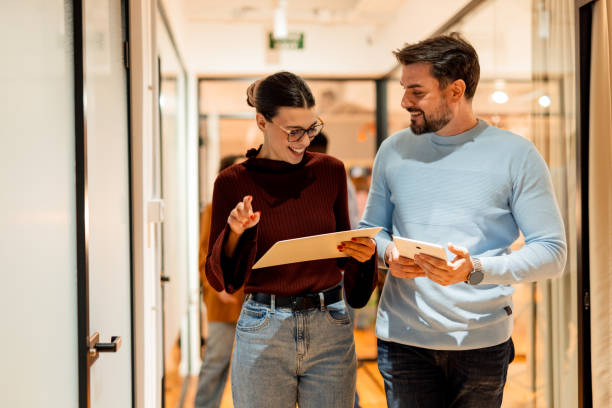 istock Business people walking and talking in office hallway 2196238833