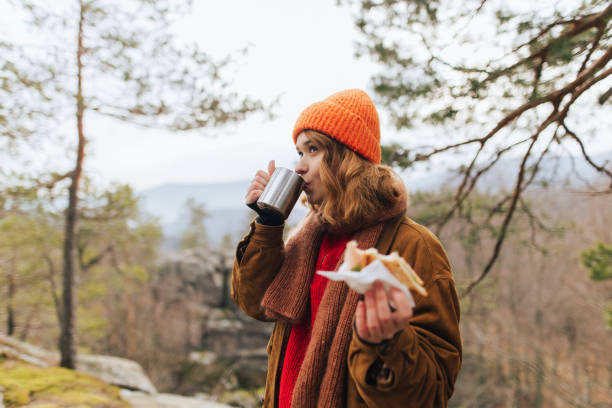 istock Young Woman Enjoying a Tranquil Lunch in the Forest 2196240025
