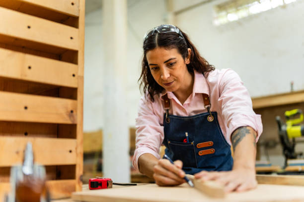 istock Mid adult carpenter woman working at carpentry 2196240784