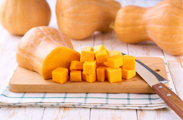 istock Diced butternut squash on wooden cutting board, selective focus. 2196241141