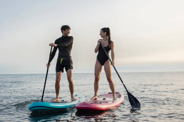 istock Couple enjoying stand up paddleboarding adventure together 2196241437