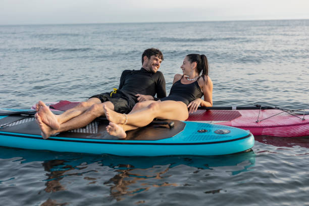 istock Couple relaxing on paddleboards in the ocean 2196241450