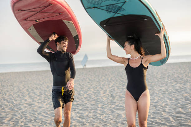 istock Couple enjoying a day of paddleboarding on the beach 2196241483