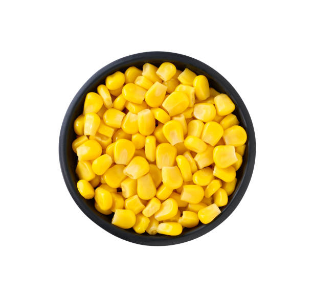 istock Black ceramic bowl of sweet corn kernels isolated on white background, top view. 2196242509