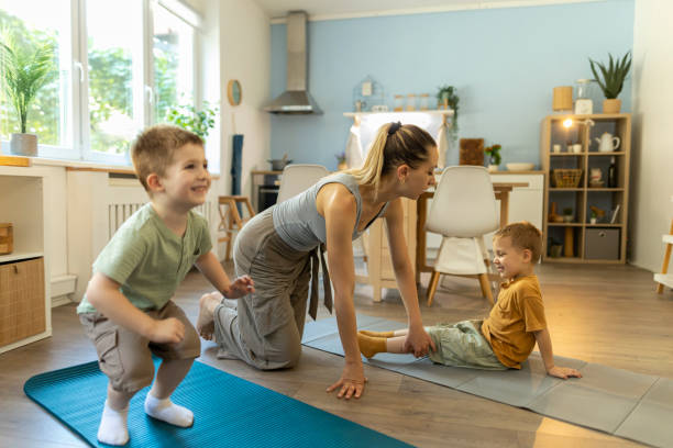istock A beautiful spring day, two boys are doing morning stretch exercises with their mom and having fun. Copy space 2196243312