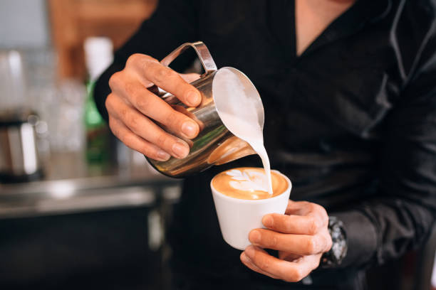 istock Barista Skillfully Pouring Latte Art Into a Cappuccino Cup 2196246006
