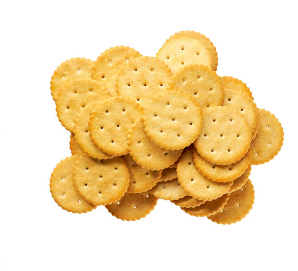 istock Heap of round salted crackers isolated on white background, top view. 2196246853
