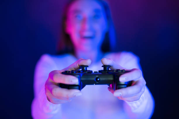 istock Excitement Rises as Player Engages in Gaming With Vibrant Lights at Night 2196247708