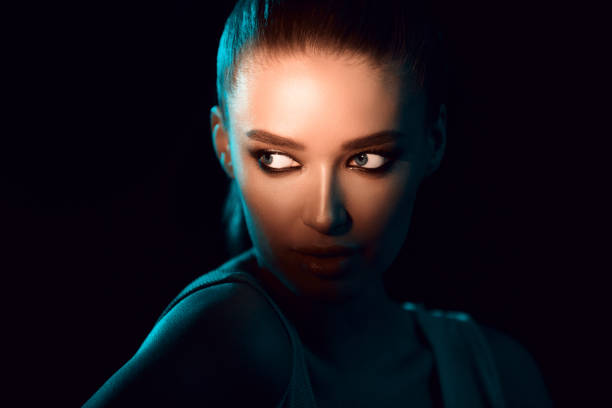 istock Model Highlighting Ethereal Beauty With Dramatic Lighting in Urban Setting at Night 2196247731